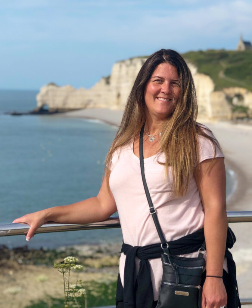 Shauni Brown in front of the cliffs at Etretat. (Paige McKinnon / The Signpost)