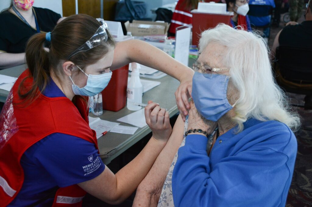 Weber State University Nursing Student, Necia Wallenmeyer administers a COVID-19 vaccination to Lorna Ricks, Tuesday Mar. 16, 2021, in Ogden, Utah. (Brooklynn Kilgore/The Signpost)