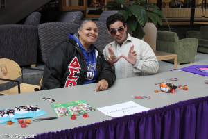 Jennifer Wylle (right) and Bryan T. Valdivieso (left) of Studetns for choice and lations in action, run a World AIDS Day booth in the Union on Tuesday.  (Ariana Berkemeier / The Signpost)