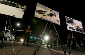 Law enforcement officials display crime scene photographs during a news briefing at the Inland Regional Center in San Bernardino, Calif., on Thursday, Dec. 3, 2015, near the scene of a mass shooting that left 14 people dead a day earlier. (Luis Sinco/Los Angeles Times/TNS)