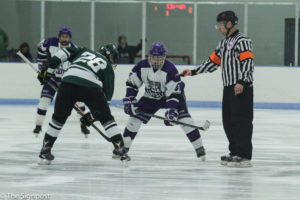 Senior Cody Bohin waits for the puck to drop during a face-off during Saturday's game. (Abby Van Ess / The Signpost)