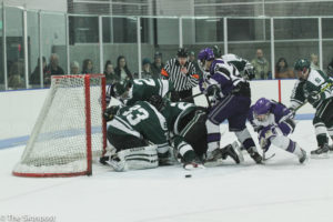 A pile-up occurs at the Michigan State goal as Weber fights to get the puck. (Abby Van Ess / The Signpost)