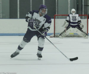 Senior Phillip Jennrich looks for an open teammate to pass the puck to during Saturday's game. (Abby Van Ess / The Signpost)