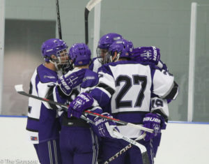 Wildcats celebrate a goal during the third period of the game on Saturday night. (Ariana Berkemeier / The Signpost)