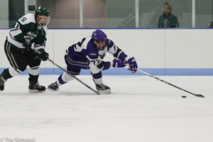 Forward Zan Hobbs trys to maintain control of the puck as he skates toward the goal. (Ariana Berkemeier / The Signpost)