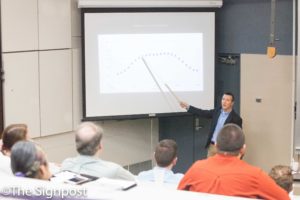 Dr. Adam Johnston shows a chart on the trajectory of a dancer's center of mass during his "Physics of the Mudane" seminar.(The Signpost/ Christina Huerta)