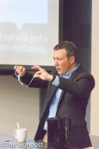 Dr. Adam Johnston uses tape to demonstrate electron attraction during his "Physics of the Mudane" seminar.(The Signpost/ Christina Huerta)