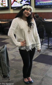 Mikaela Martinez, a freshman studying US History, shows off her style wearing a white rose headband, an off white sweater, black pants and flats. (Ariana Berkemeier / The Signpost)