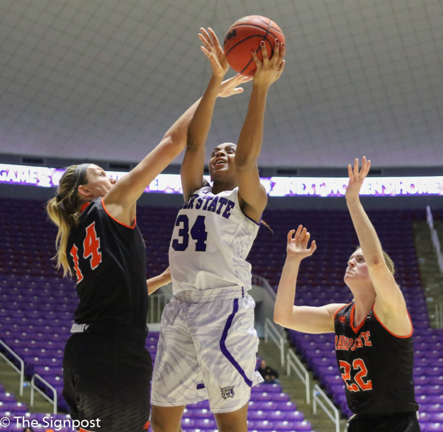 Senior Regina Okoye attempts a layup in between two Idaho State defenders. (Gabe Cerritos / The Signpost)