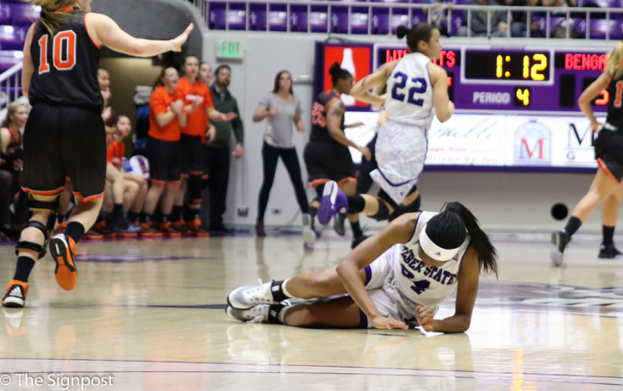 Regina Okoye was helped off the court late in the fourth quarter; she did return to finish the game. (Gabe Cerritos / The Signpost)
