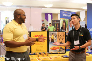 Eric Williams and Nick Chan from DHL Express talk about the benefits of their company at the WSU Career Fair on Tuesday. (Abby Van Ess / The Signpost)