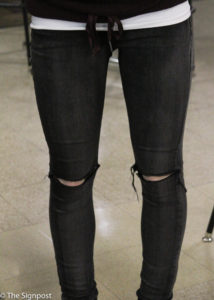 Abby Holbrook rocks her dark grey ripped jeans that add an edgy look to her outfit. (Ariana Berkemeier / The Signpost)