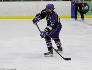 Defender Jake Webber passes the puck to an open Wildcat during the game on January 29. (Ariana Berkemeier / The Signpost)