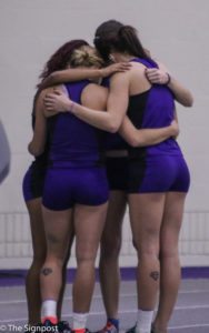 Weber State runners Tawnie Moore, Ashlynn Allred, Candace Bowman, and Alexandria Van Halder huddle together before the finals of the 55m dash. (Gabe Cerritos / The Signpost)