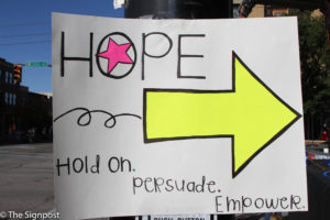 A poster at the annual NUHOPE Suicide Awareness Walk encourages those to hold on and empower.