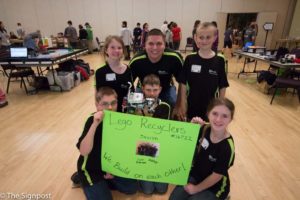 The Lego Recyclers team pose with their robot at the FIRST Lego League Qualifier Tournament in the Shepherd Union on Saturday, Jan. 9. The event was hosted by Weber State University's College of Engineering, Applied Science & Technology. (Daniel Rubio / The Signpost)
