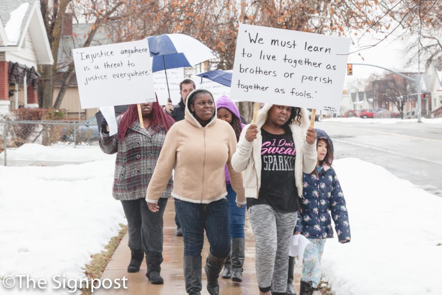 Akeara Belt, 10 carries a sign with a MLK quote during the annual Martin Luther King Jr. celebration march. (Christina Huerta/The Signpost)