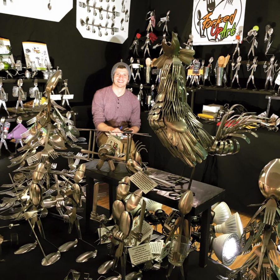 General manager of Forked Up Art, Landon Kunzler, featuring a variety of artwork pieced together from forks and spoons. Photo credit: Forked Up Art