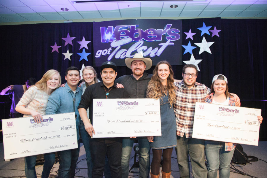 Second place winner Caralee Wallentine, first place winners Stillwater and third place winner Erin Dominguez show off their giant checks after winning in the Webers got Talent competition.(Christina Huerta/The Signpost) Photo credit: Christina Huerta