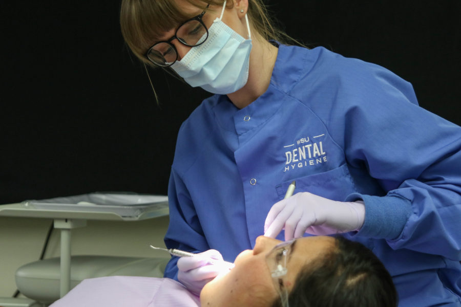 Senior Ali Horton works on her patient at the Dental Hygiene Clinic. (Gabe Cerritos / The Signpost)