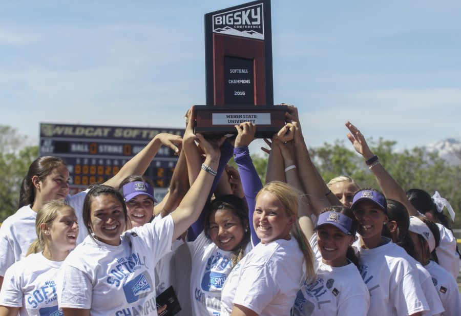 Weber State womens softball team hold up the Big Sky Conference championship trophy after defeating Idaho State 4-2 on Saturday, May 14. Weber will move on to Seattle, Washington for the NCAA Softball Regionals. (Emily Crooks / The Signpost)