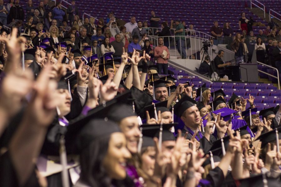 Graduating Weber State students form Ws with their hands. (Dalton Flandro / The Signpost)