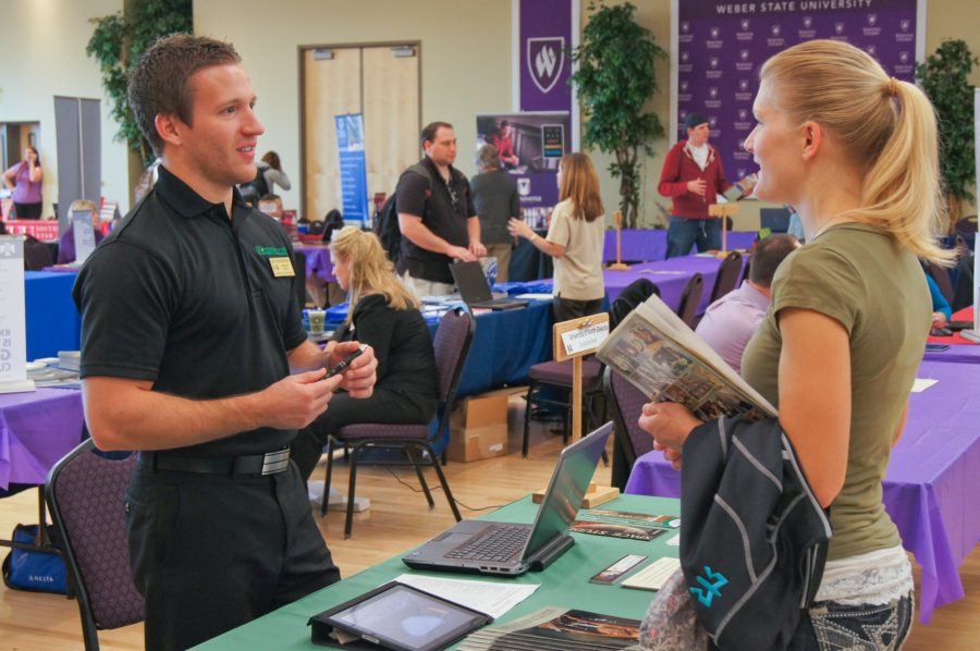 Mke Hinschberger (left) from the University of North Dakota speaks Weber State University student Mindy Brown (right) at the Grad Fair 2012 (The Signpost Archives)