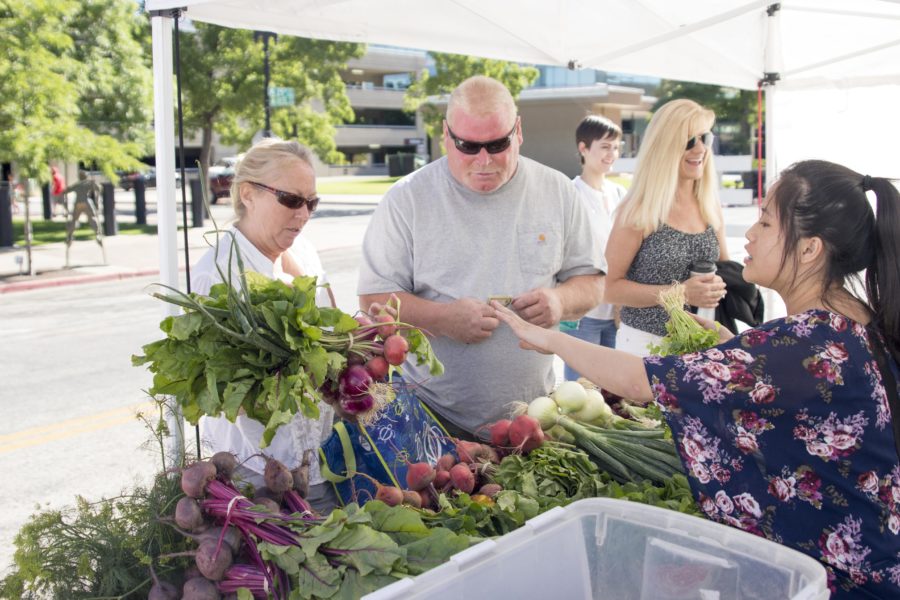 Locals buy produce at the Ogden farmers market on Saturday, June 25. The first fall market will begin in October. (Dalton Flandro / The Signpost)