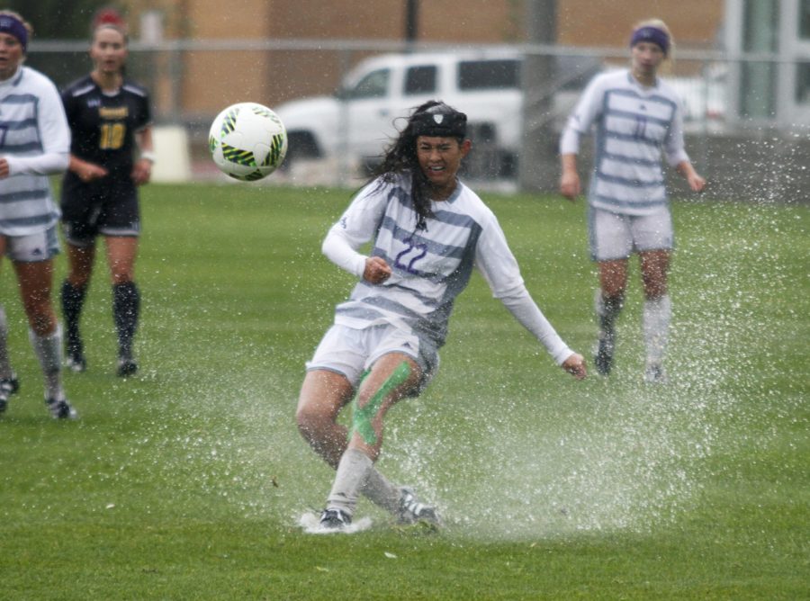 Freshman Amy Chidester forcefully kicks the ball in the rain during the match up against UNC Sept 23. (Abby Van Ess / The Signpost)