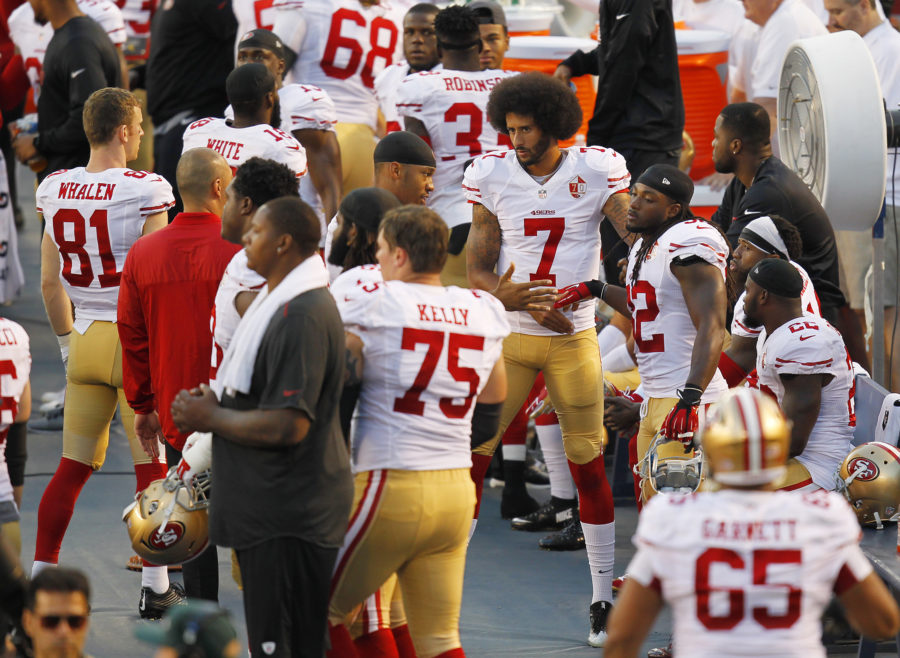 San Francisco 49ers quarterback Colin Kaepernick (7) greets players after taking a knee during the national anthem before a preseason game against the San Diego Chargers on Thursday, Sept. 1, 2016, at Qualcomm Stadium in San Diego. (K.C. Alfred/San Diego Union-Tribune/TNS)