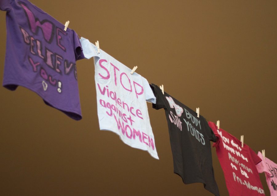 Painted T-shirts addressing violence against women hang along a clothesline above the Union atrium. The shirts were made for The Clothesline Project, hosted by Weber State Universitys Womens Center. (Emily Crooks / The Signpost)