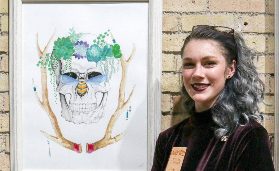 Kayla Varnell with her piece at the Downtown Artist Collective Oct 21. (Abby Van Ess / The Signpost)