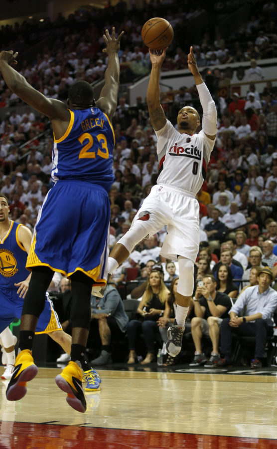 The Portland Trail Blazers Damian Lillard (0) takes a shot against the Golden State Warriors Draymond Green (23) in the fourth quarter of Game 3 in the Western Conference semifinals at the Moda Center in Portland, Ore., on Saturday, May 7, 2016. The Blazers won, 120-108, to trim the Warriors series lead to 2-1. (Nhat V. Meyer/Bay Area News Group/TNS)