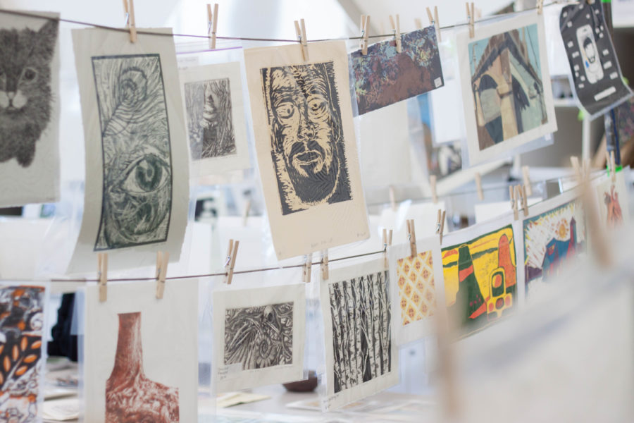 Prints made by students at Weber State University hang on display in Kimball Art Centers printmaking studio for the Annual Holiday Clothesline Print Sale on Nov. 18. The last sale of the semester will be held on Dec. 14 and 15. (Emily Crooks / The Signpost)