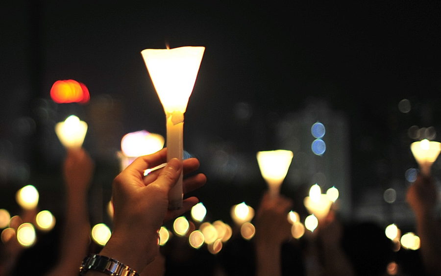 Candles are raised in Hong Kong in 2009. Two English instructors at Weber State University have organized a vigil in Ogden, UT to support peace, following national elections, on Nov. 22. (Source: David Yan / flickr)