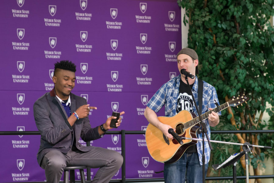 Comedian Evan Wecksell, right, performs one of his songs alongside Chibuike Chikere-Njo, the master of ceremonies for the Laugh Out Loud social mixer. (Joshua Wineholt / The Signpost)