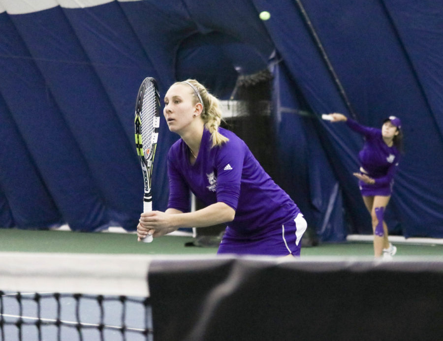 Sophomore Morgan Dickason serves the ball while playing doubles with junior Dominique Beauvais Jan 27 against North Dakota. (Abby Van Ess / The Signpost)