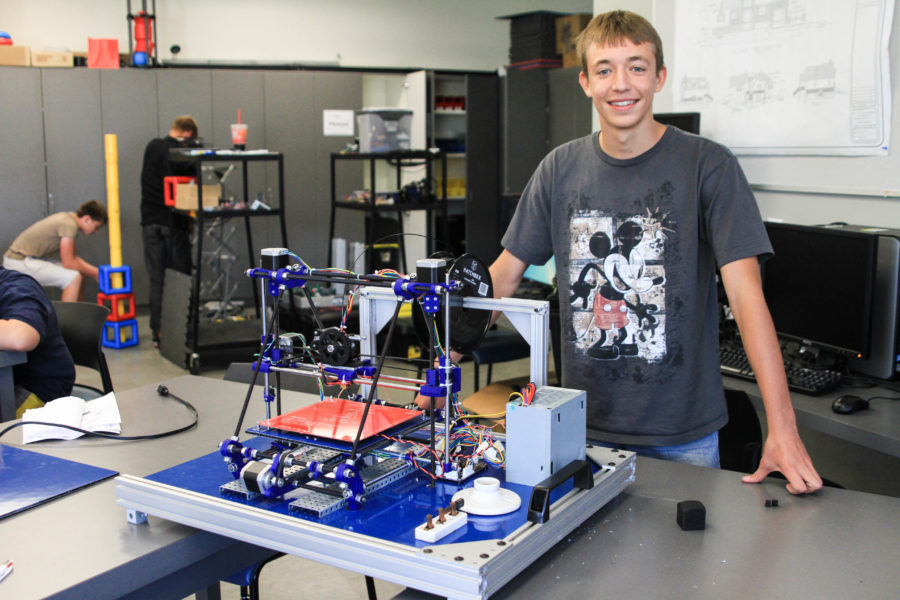 Hudson Kendall of NUAMES stands behind a 3-D printer he built with a mentor in Fall 2014. WSUSA executives discuss involving NUAMES students in more activities. (The Signpost Archives)