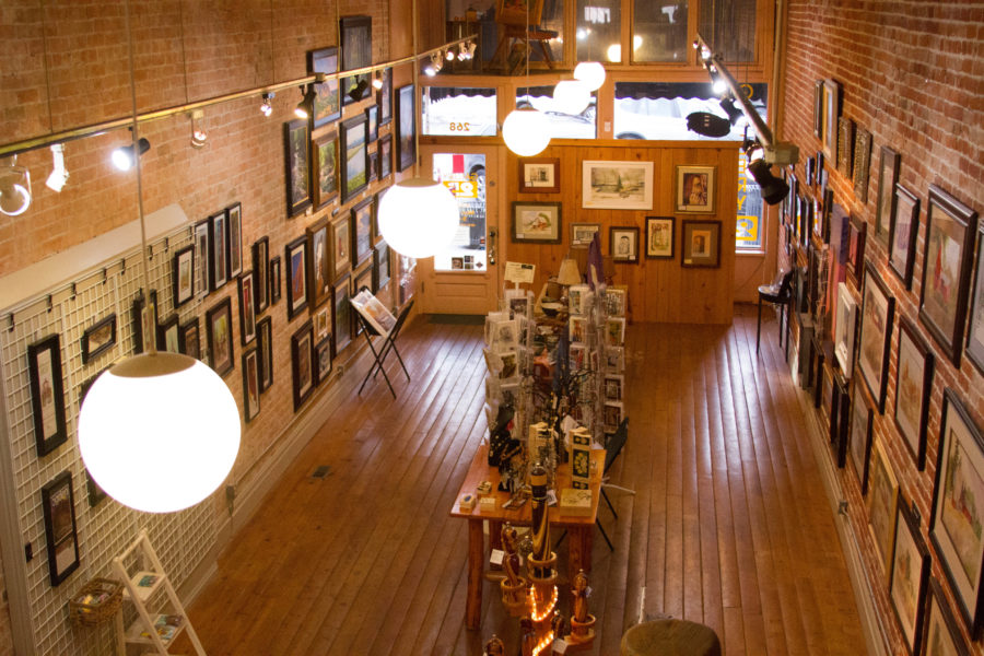 From above the main floor of Historic 25th Streets Gallery 25, artworks of all mediums collage the walls. (Kayla Winn / The Signpost)
