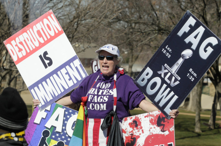 A member of the Westboro Baptist Church makes her point with signs in the free speech area outside the stadium before the start of Super Bowl XLV in 2011. (Source: Tribune News Service)