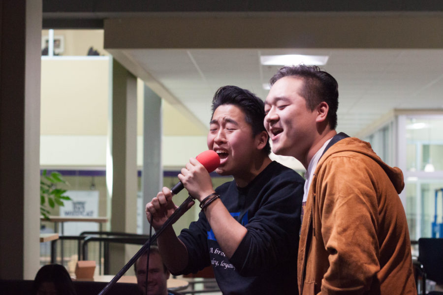 Brian Choi, left, sings karaoke with a friend at Waldos Corner Pocket on Mar. 1. (Emily Crooks / The Signpost)