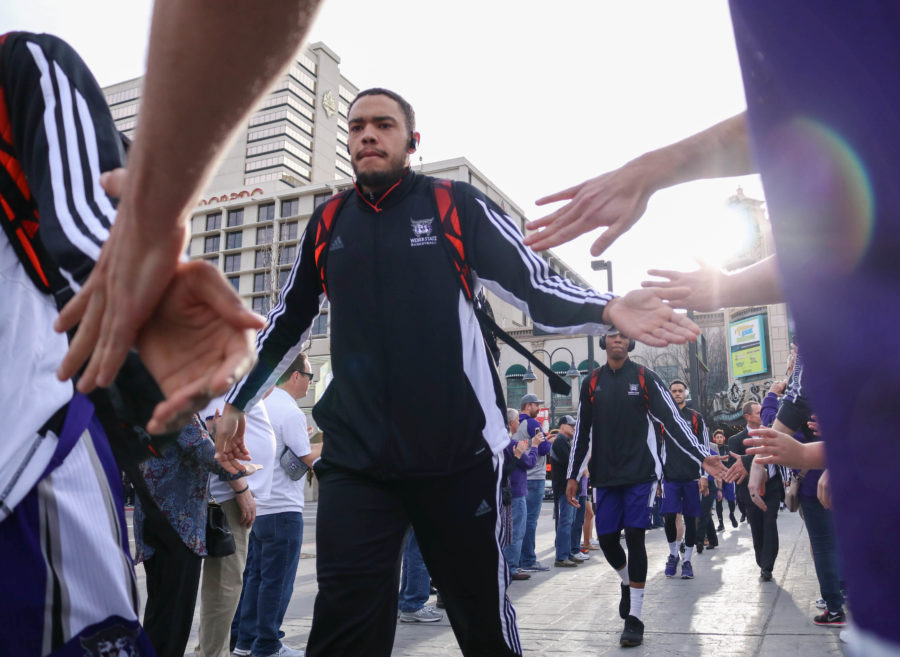 Zach Braxton high fives Weber State basketball fans before the March 11 game against North Dakota. (Abby Van Ess / The Signpost)
