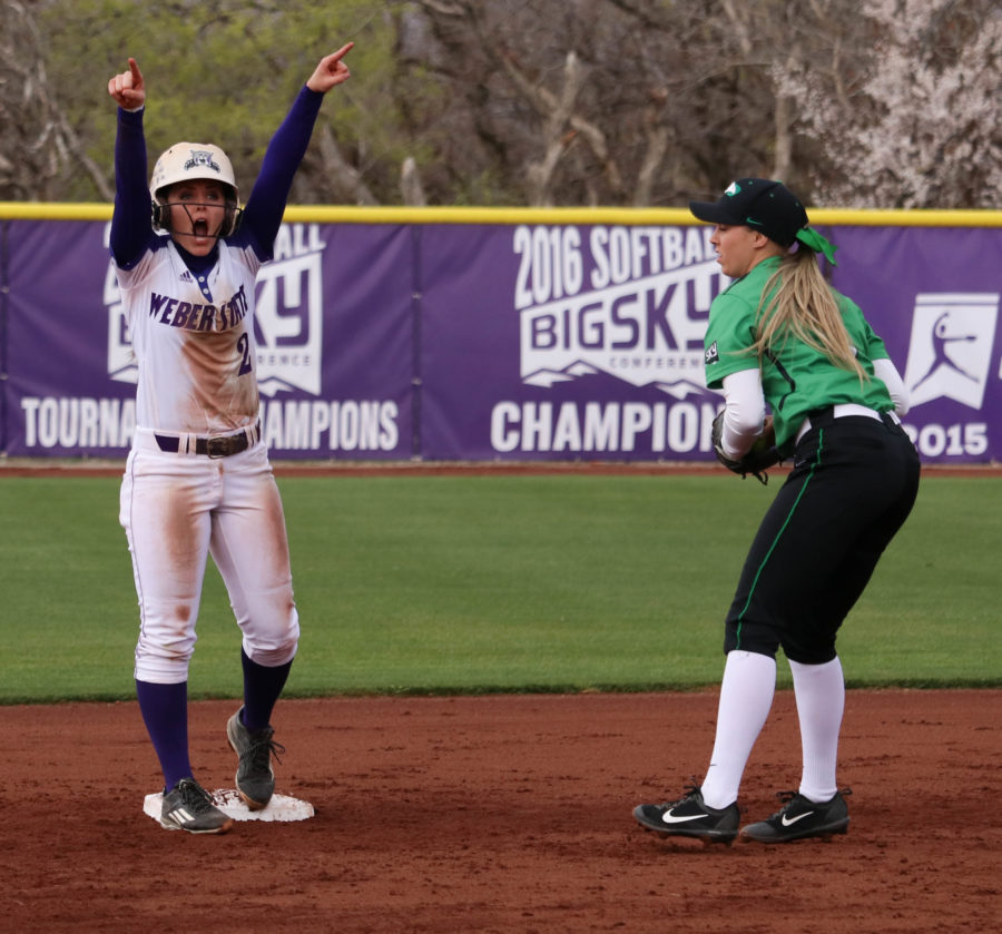 Junior McKinley Brinkerhoff cheers towards the Wildcats after she makes it to second safely on Mar 31 against North Dakota. (Abby Van Ess / The Signpost)