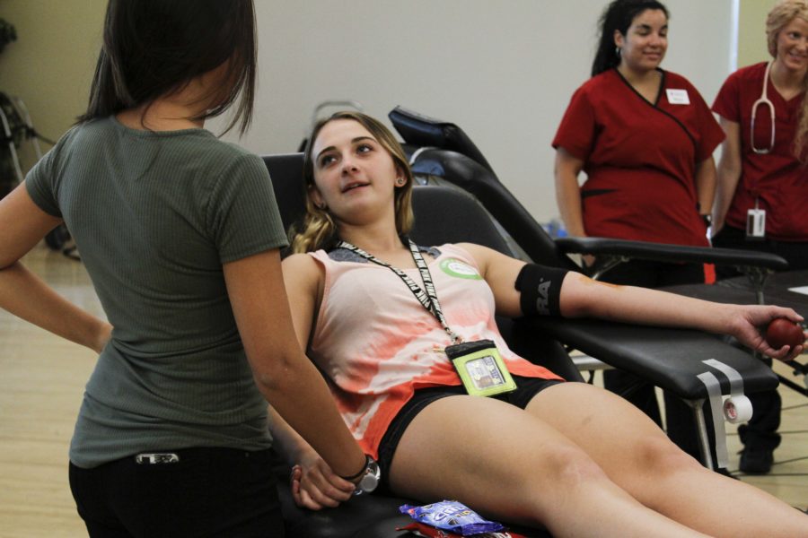 Rebecca Maringer, freshman in Public Relations & Advertising, holds hands with Daysia Willden, BIS Sophomore, while Willden is prepped for a blood donation at Weber State Universitys blood drive on Thursday, Sept 1. (Emily Crooks / The Signpost)