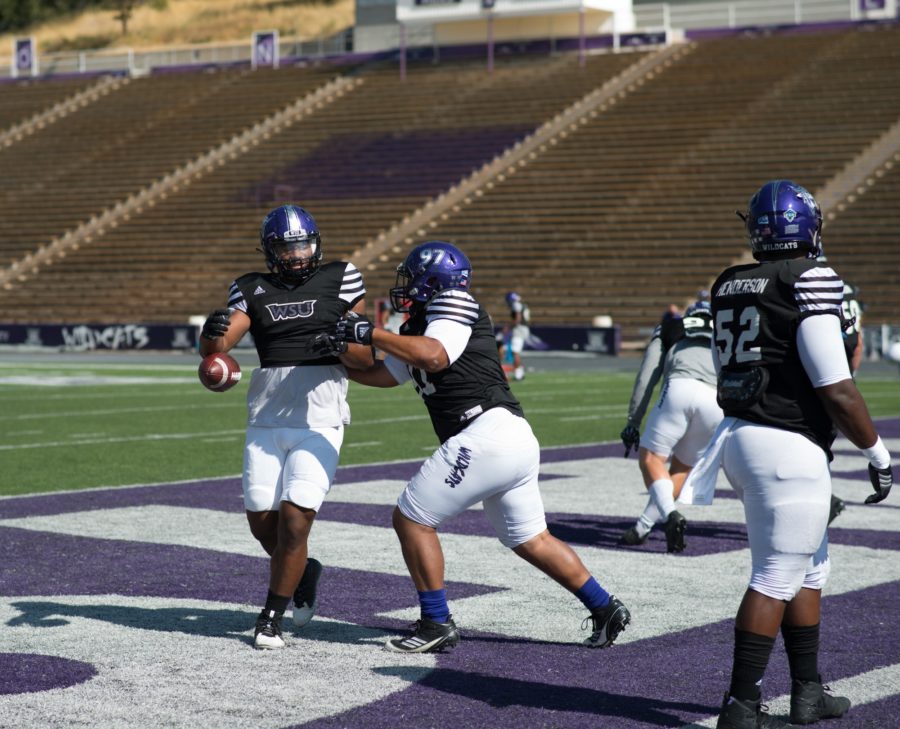 Two-man teams practice stripping ball-carriers of their possession.  (Joshua Wineholt / The Signpost)