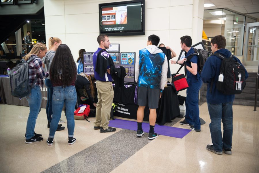Attendees of the Student Services Expo crowd around the Weber State Recreation booth. (Joshua Wineholt / The Signpost)