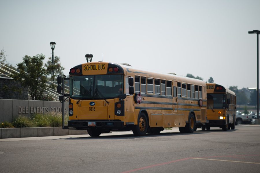School buses sit in front of the Dee Events Center, after having been used to evacuate grade-schooler children. (Joshua Wineholt / The Signpost)