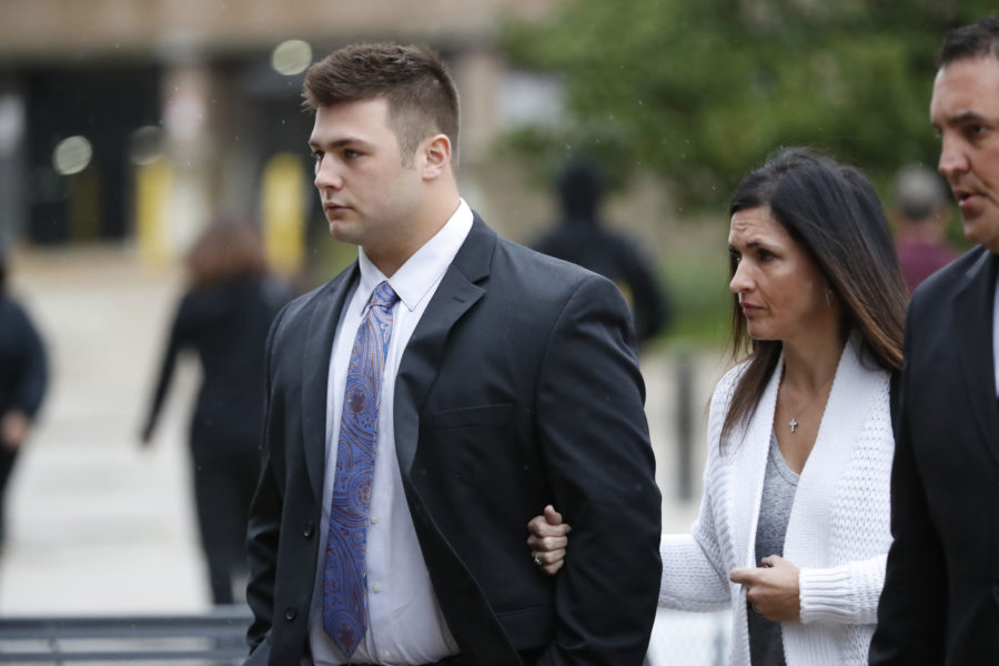 Noah Spielman, left, arrives to the DuPage County Courthouse in Wheaton with his attorney, Mark Sutter, far right, and step-mother Carrie Spielman on Monday, Oct. 23, 2017. Four of the five Wheaton College football players who are facing felony charges for an alleged 2016 hazing incident involving a freshman teammate will be arraigned in their first court appearance since being charged with aggravated battery, mob action and unlawful restraint last month.  (Jose M. Osorio/Chicago Tribune/TNS)