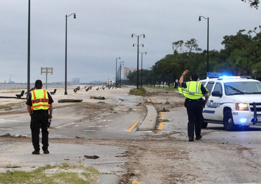 Gulfport police officers shoo away a sightseer before the curfew was lifted on Sunday, Oct. 8, 2017 after Hurricane Nate hit the area. (John Fitzhugh/Biloxi Sun Herald/TNS)