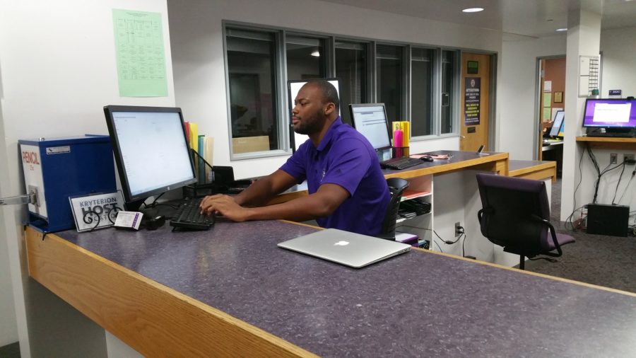 Student Carter Smith working at the testing center in the Student Services Building.